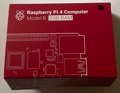 Raspberry Pi 4 Computer box, red with white letters. Model B, 2GB Ram